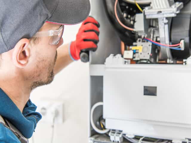 a technician checking a furnace